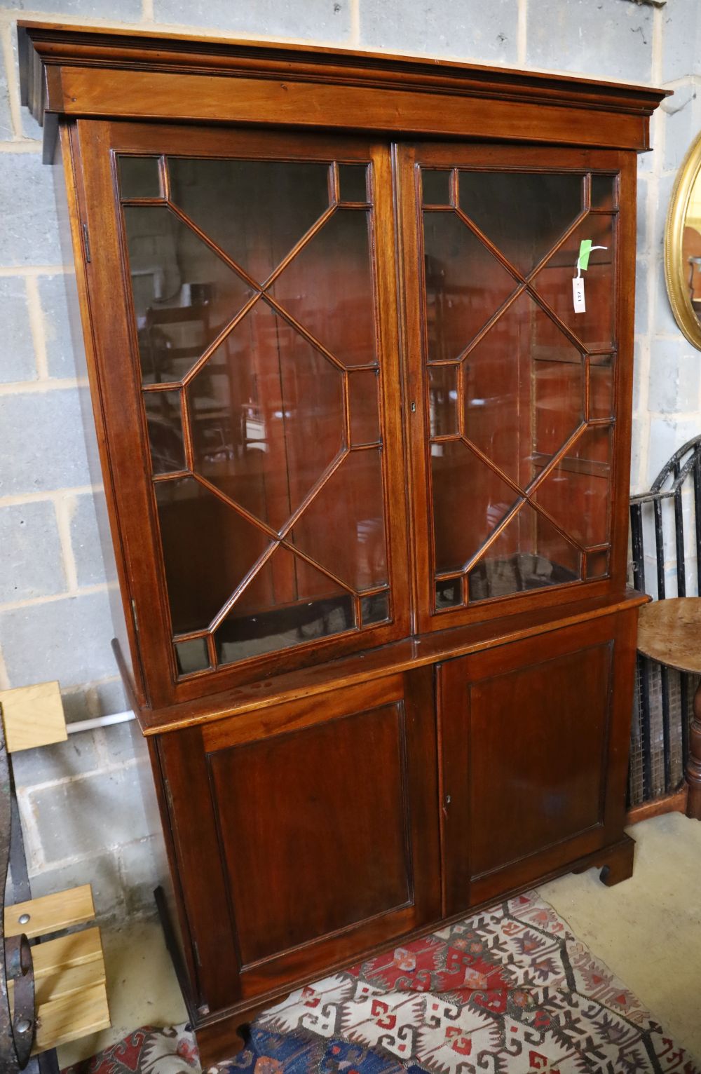 A Georgian style mahogany glazed bookcase, width 116cm, depth 44cm, height 194cm